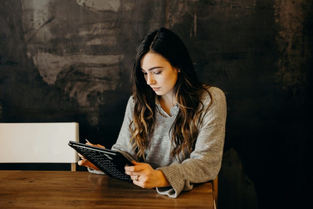 Woman holding a tablet, representing email marketing