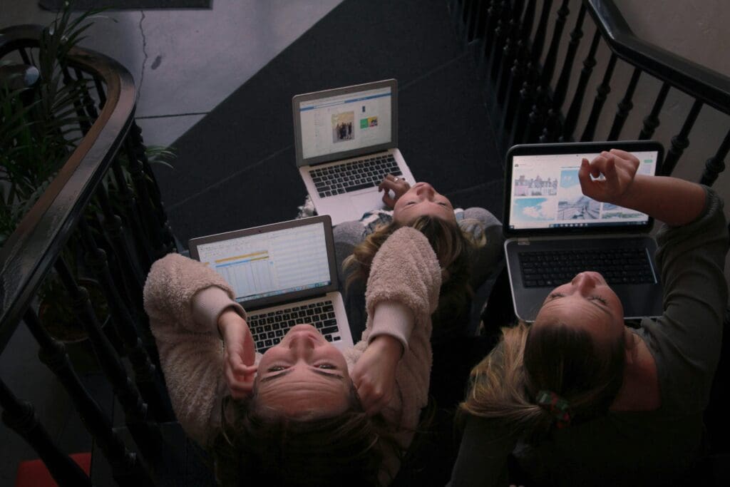 Three marketers analyzing SEO data on laptops